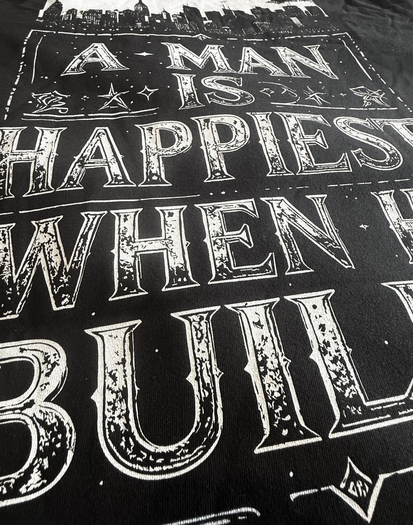 Black Unisex Premium Original Heavyweight Back-Design Tee "A Man is Happiest When He Builds" by Designer and Artist Lucas Gillon