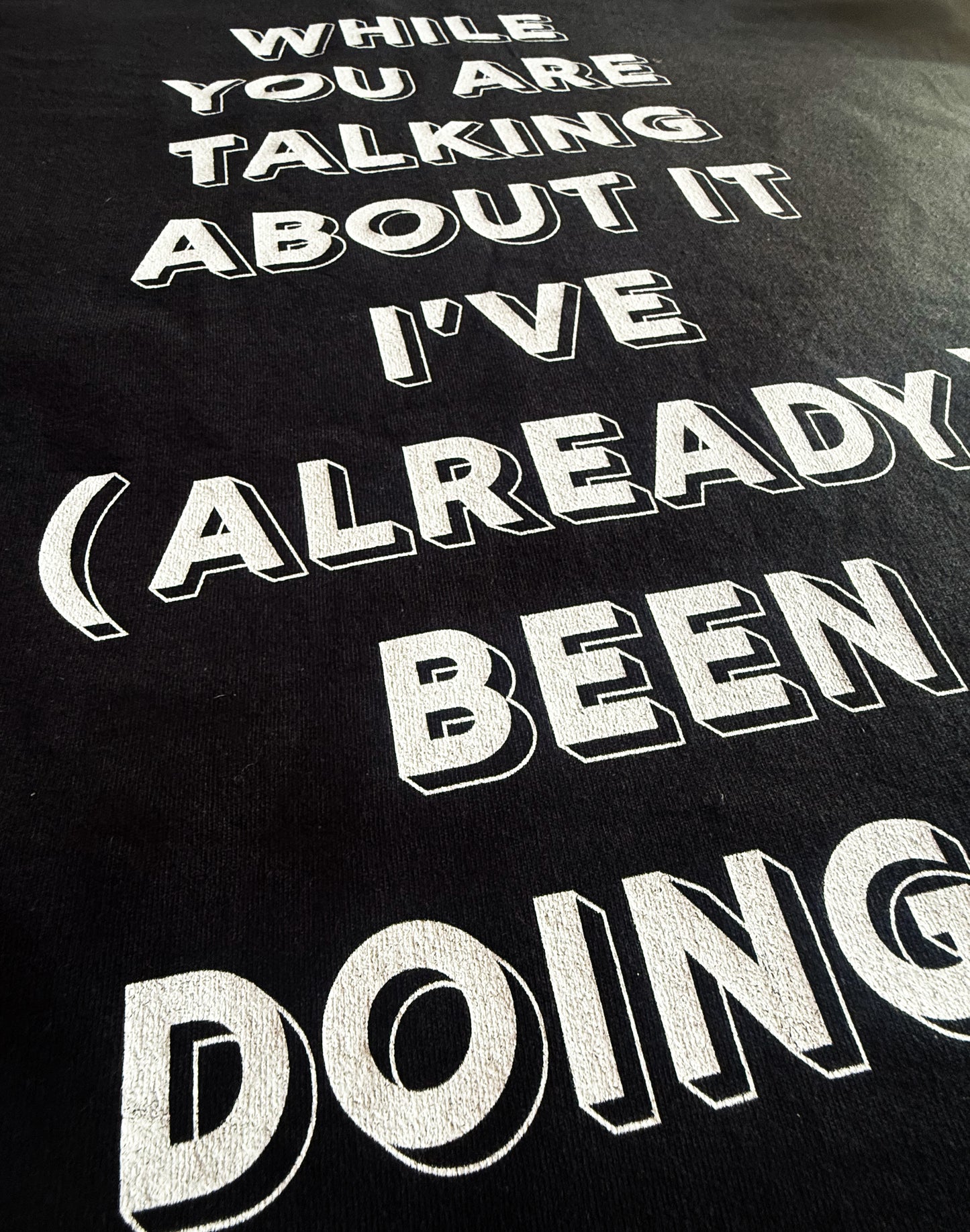 Black Unisex Heavy Premium Back-Design Tee "Already Doing It" by Designer and Artist Lucas Gillon
